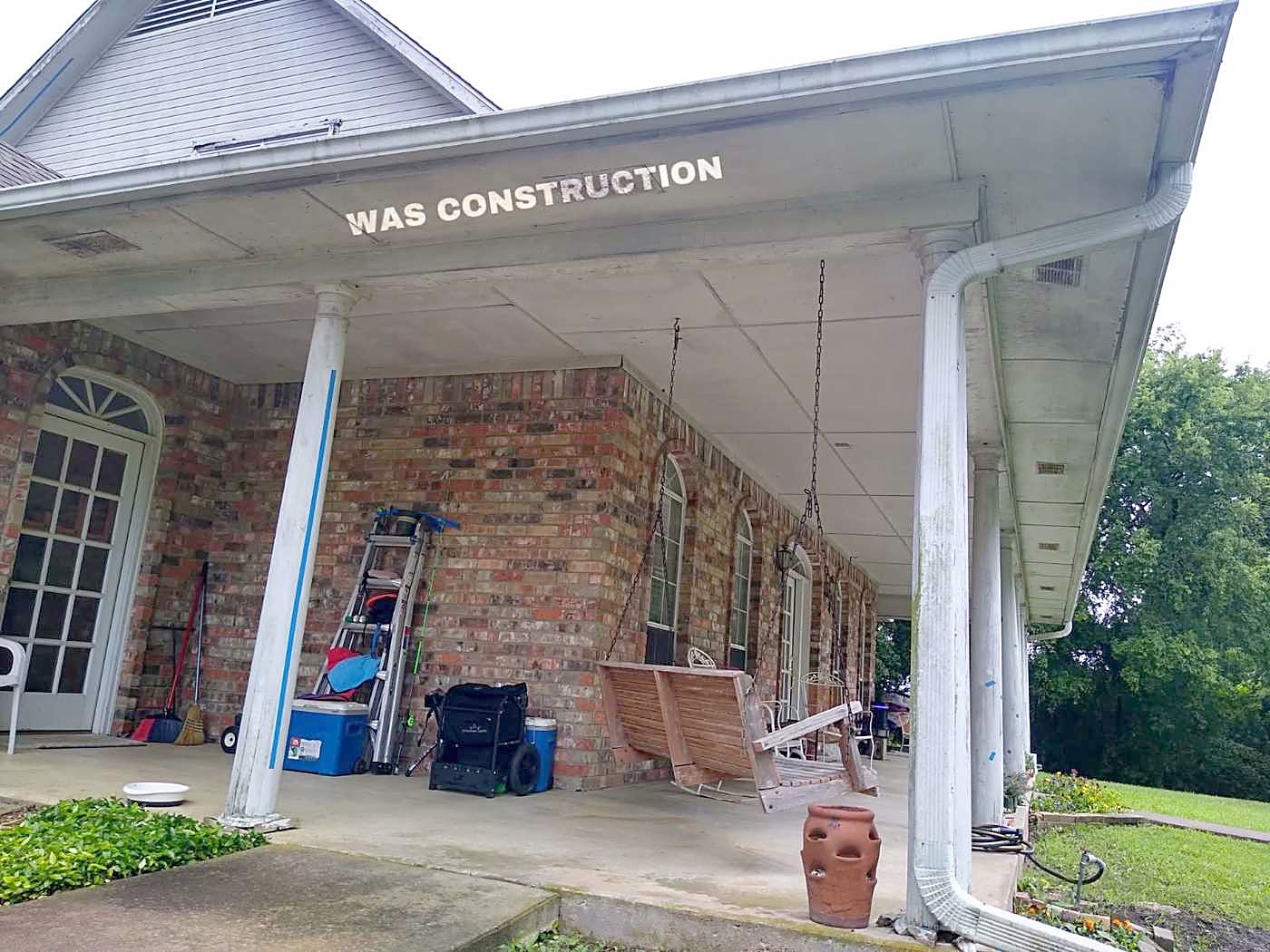 A covered porch and white columns on a brick home