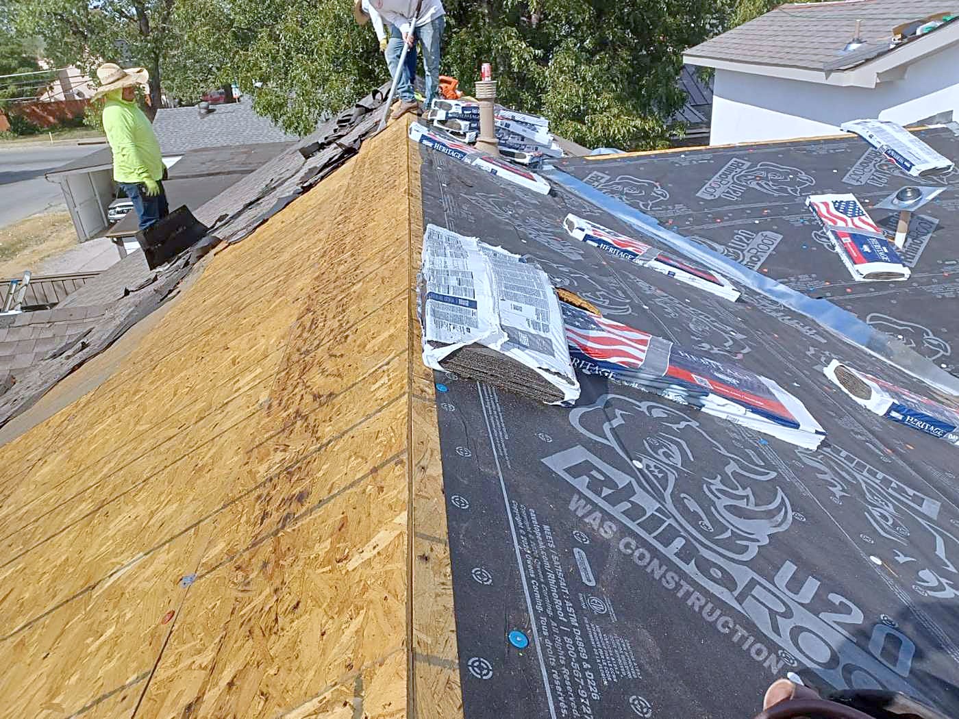 New decking and underlayment going down across an open roof